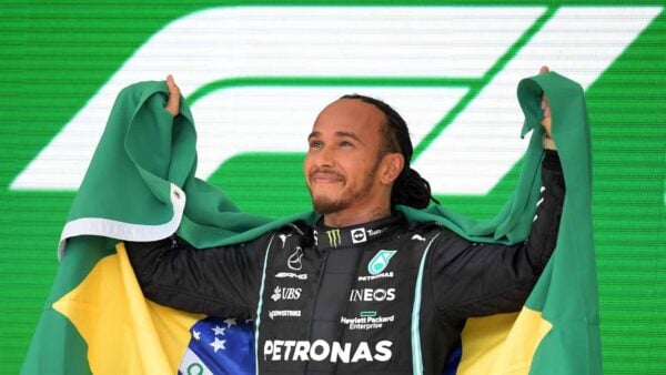 Lewis Hamilton holding the Brazilian flag (Via Formula 1)